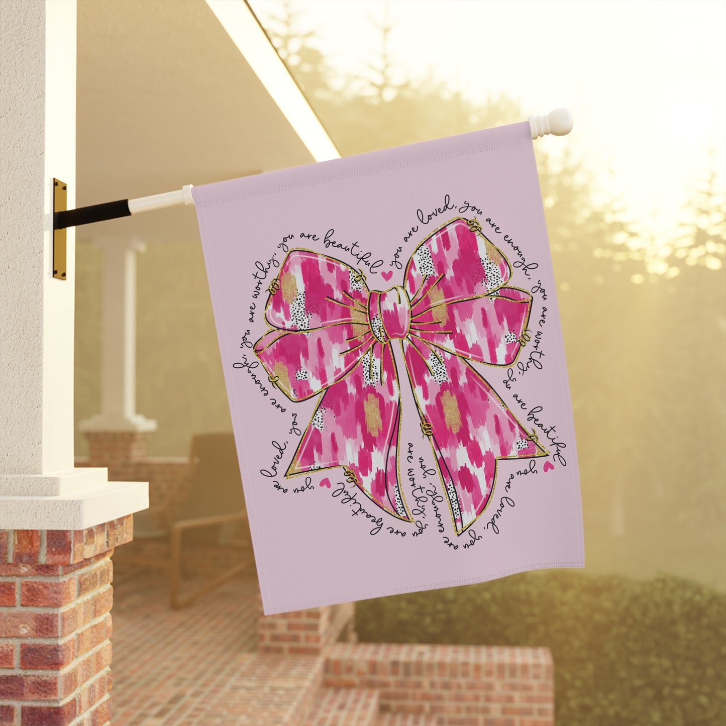 Valentines pink bow garden flag with painterly bow design and handwritten affirmations you are loved you are worthy you are beautiful around it