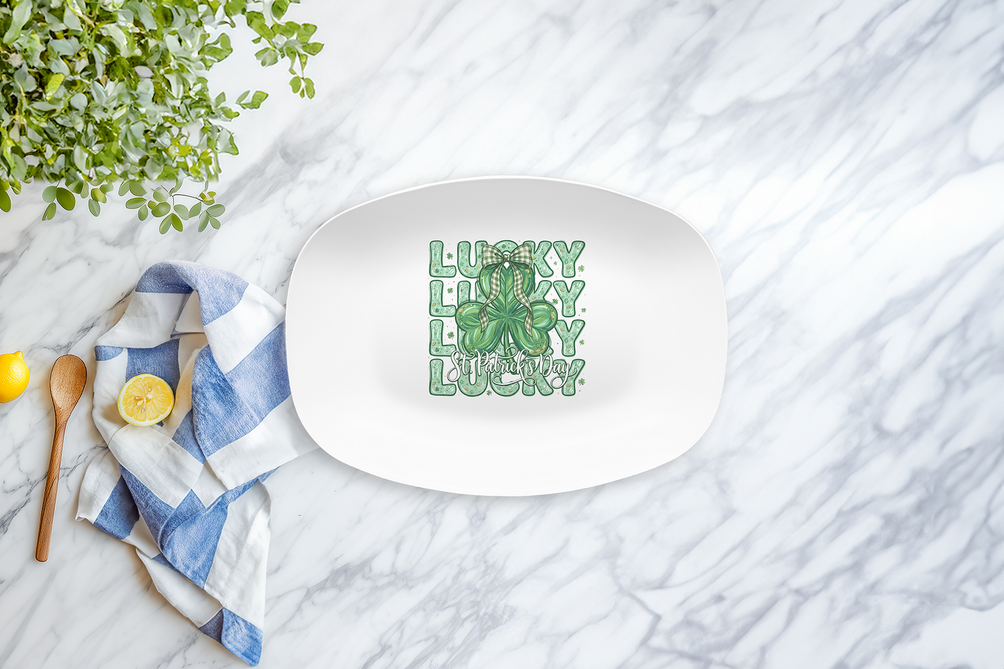 White oval plate with 'Lucky' text and shamrock design on a marble surface with a lemon and towel.