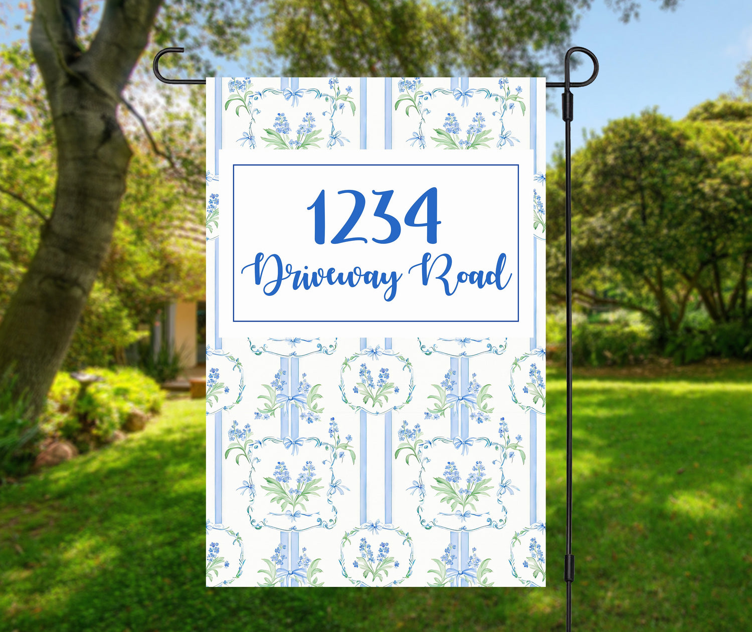 Garden & Porch Flags with house number 1234 Driveway Road displayed on a decorative flag in a lush garden.