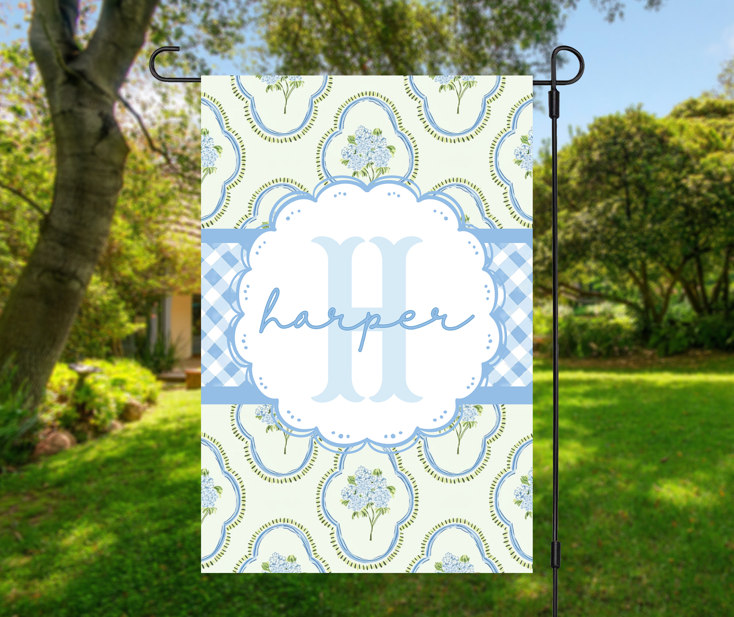 Garden & Porch Flags with house number 1234 Driveway Road displayed on a decorative flag in a lush garden.
