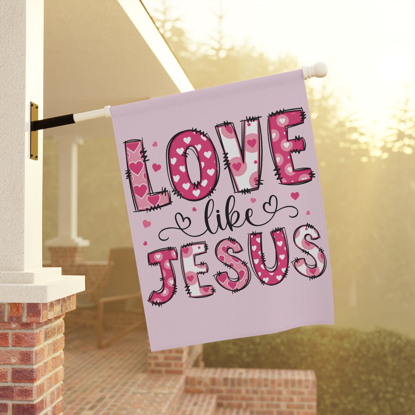 Christian Valentines yard flag that says Love Like Jesus, hanging on garden flag stand in front yard