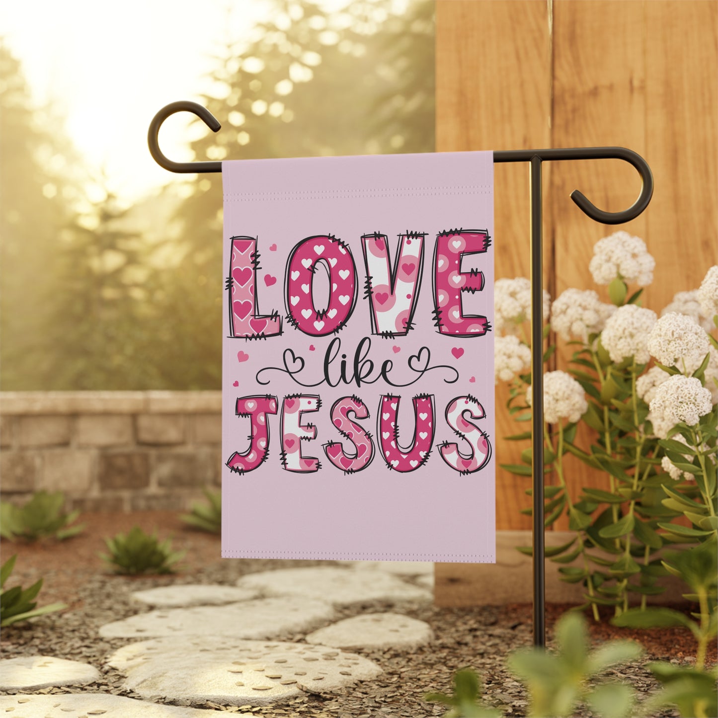 Christian Valentines yard flag that says Love Like Jesus, hanging on garden flag stand in front yard