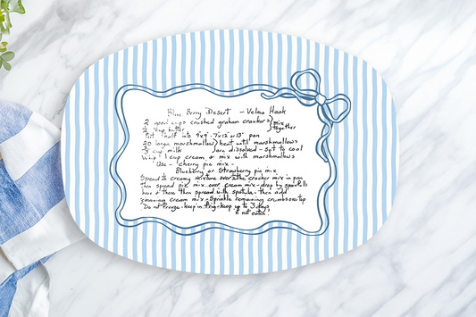 Blue and white striped placemat with text on a marble surface with a lemon and towel.