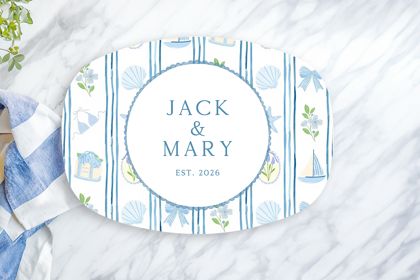 Personalized oval serving platter featuring elegant blue coastal stripes with nautical accents including sailboats, seashells, bows, and florals. Customized with the couple's names and established year, this timeless serving tray is perfect for beach house entertaining, weddings, anniversaries, and coastal home décor.