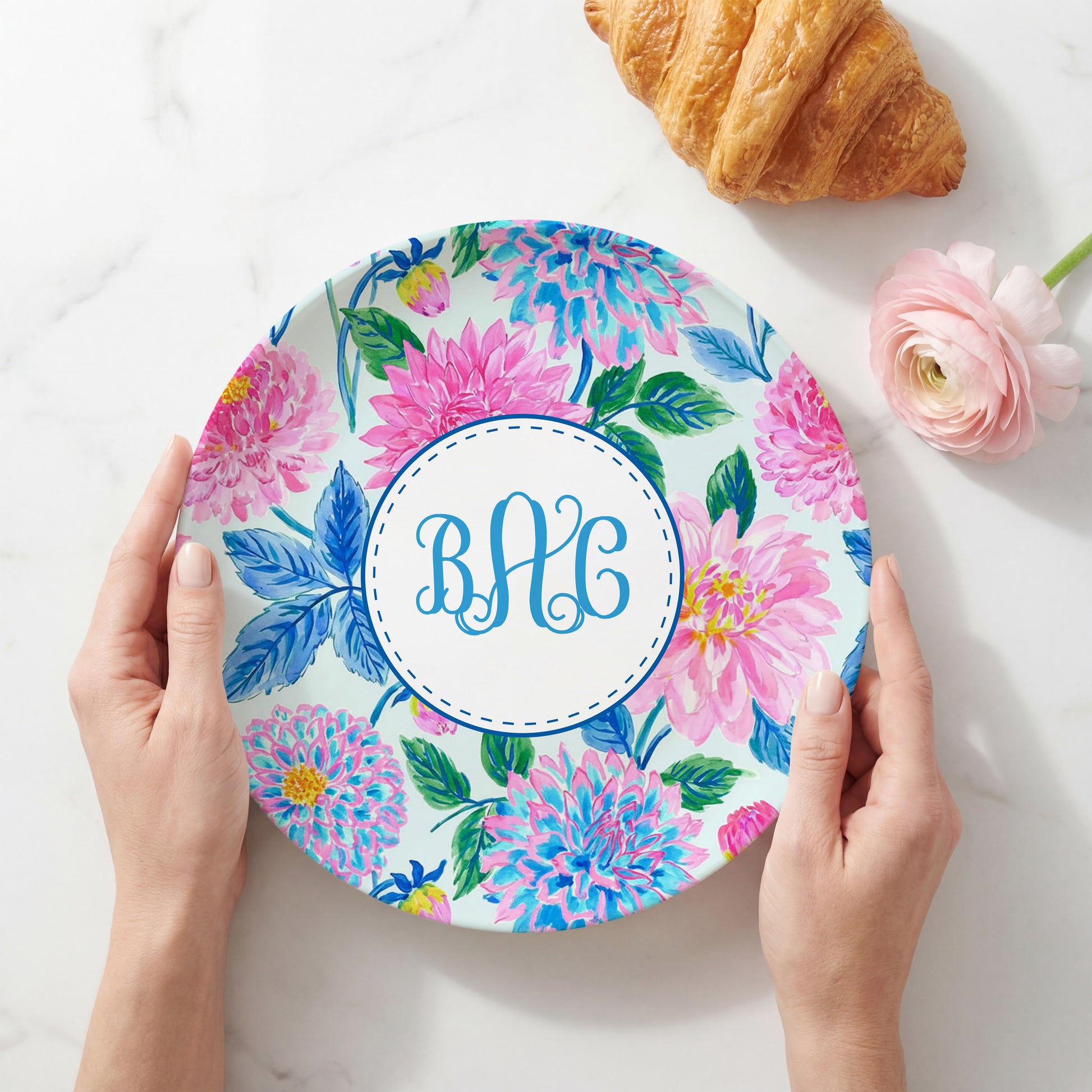 Personalized melamine plate featuring a vibrant pink and blue dahlia floral pattern with a custom three-letter monogram in the center, perfect for personalized table settings and gifts.