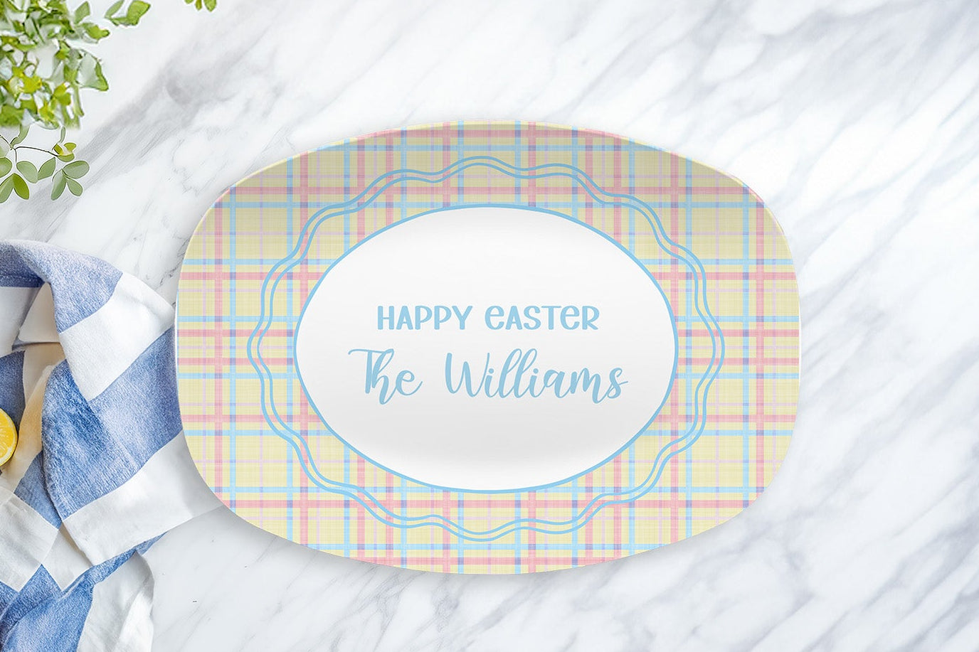 Personalized Easter placemat with 'Happy Easter The Williams' text on a marble surface with a towel and lemon.