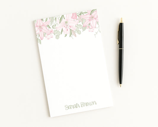 Floral notepad with a pen on a white background