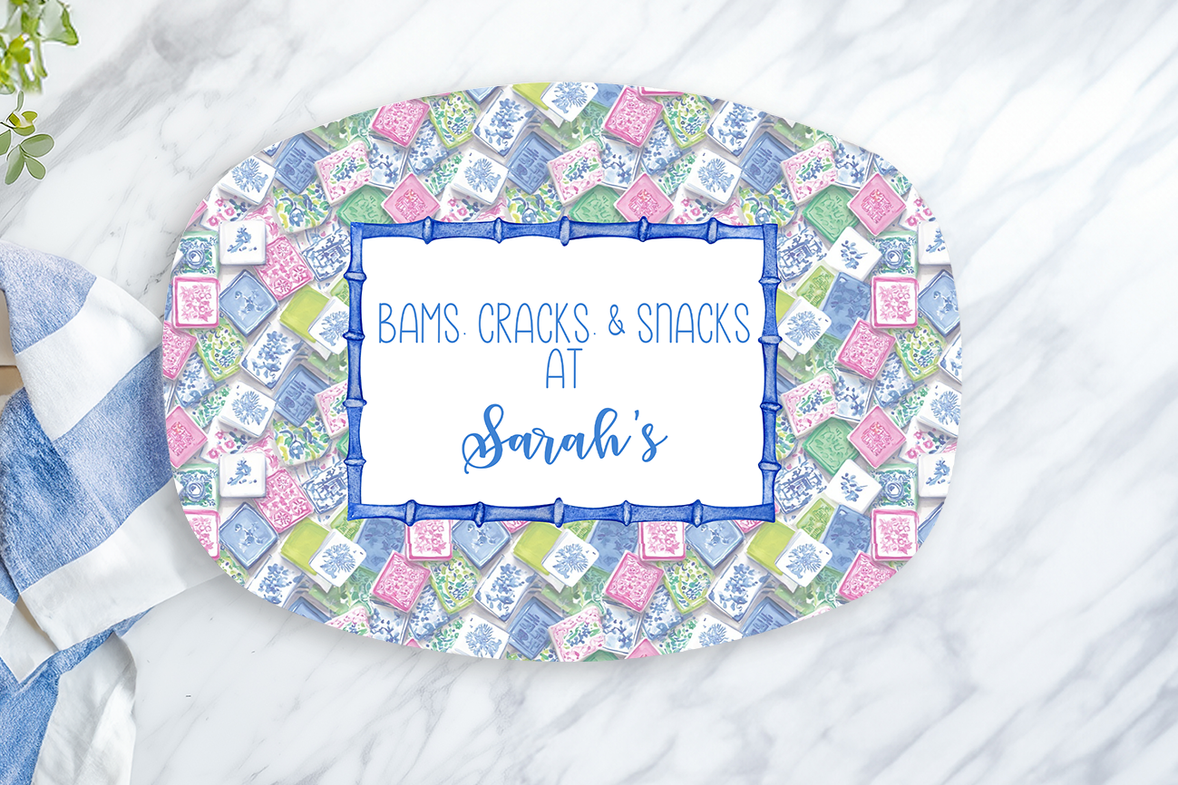Decorative plate with floral pattern and text on a marble surface with a lemon and towel.