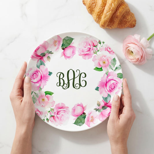 Personalized white plate featuring a watercolor wreath of soft pink roses and green leaves surrounding a custom three-letter monogram. Perfect for weddings, Mother's Day, housewarming gifts, personalized home décor, and elegant everyday dining.
