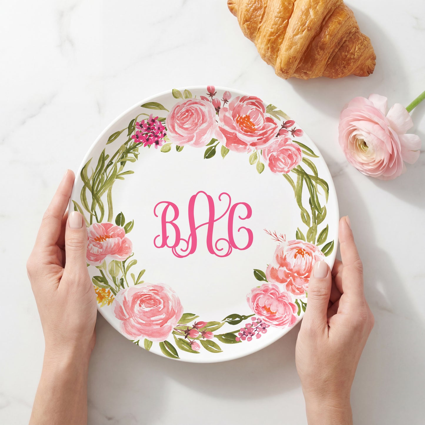 Personalized white plate featuring a watercolor wreath of soft pink roses and greenery surrounding a custom three-letter monogram, creating an elegant floral plate for weddings, housewarmings, and personalized home décor.