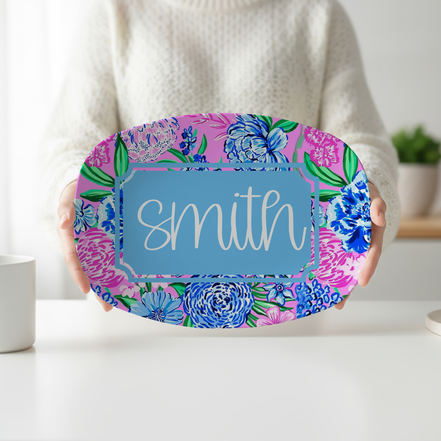 Personalized oval serving platter featuring vibrant pink and blue preppy floral artwork, a custom blue nameplate, and personalized family name. Decorative serving tray perfect for weddings, housewarming gifts, entertaining, and colorful kitchen décor.