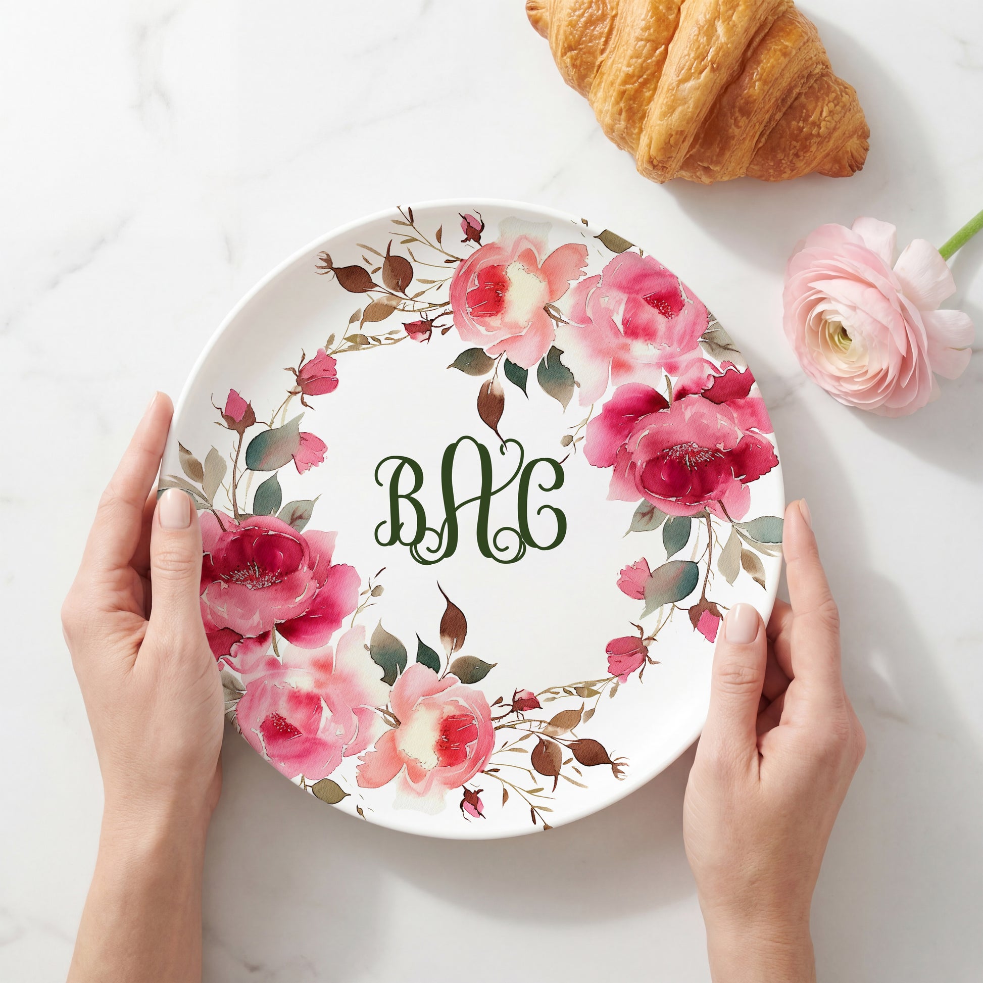 Personalized white plate featuring a vibrant watercolor wreath of pink roses and botanical greenery surrounding a custom three-letter monogram, creating an elegant floral plate perfect for weddings, housewarmings, Mother's Day, and personalized home décor.