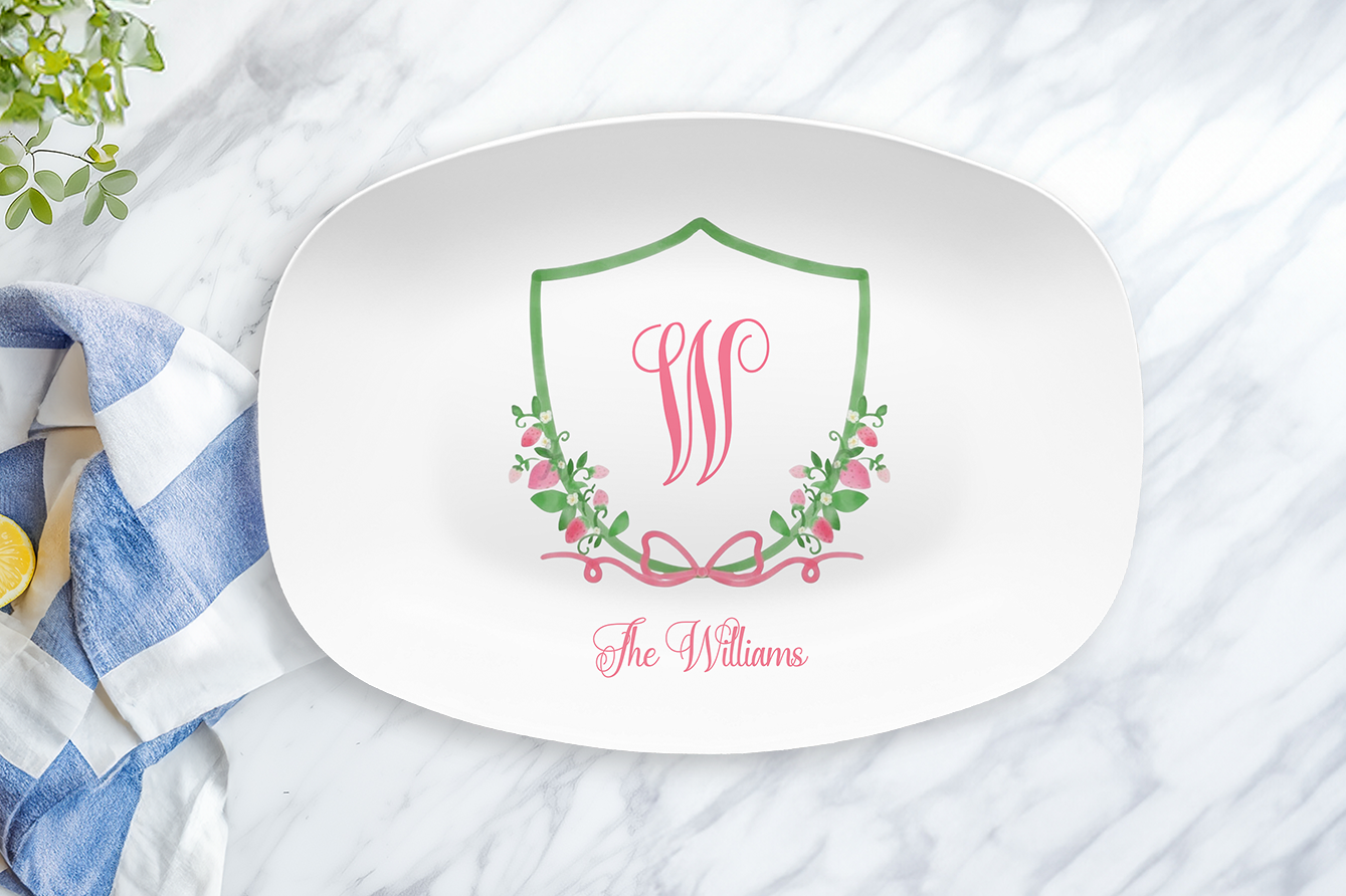 White plate with decorative monogram and text on a marble surface