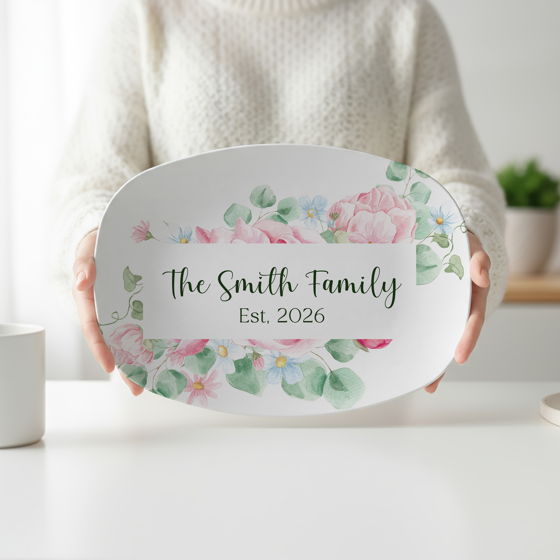 Personalized oval serving platter featuring watercolor blush pink roses, soft blue flowers, eucalyptus greenery, custom family name, and optional established year. Elegant floral serving tray perfect for weddings, housewarming gifts, entertaining, and personalized kitchen décor.