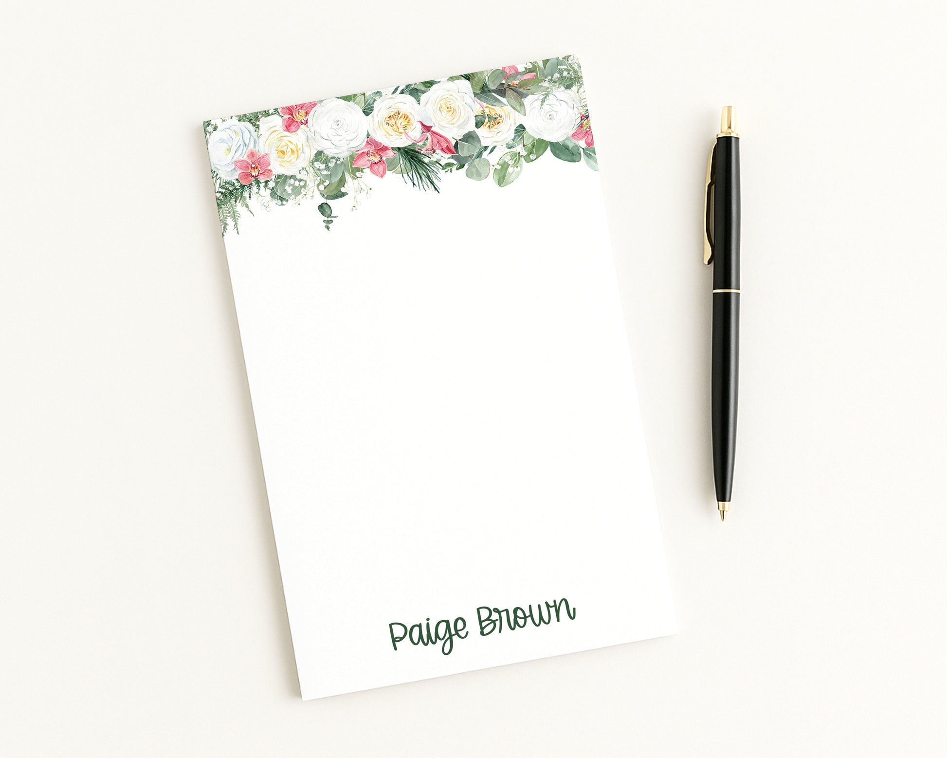 Floral notepad with a pen on a white background